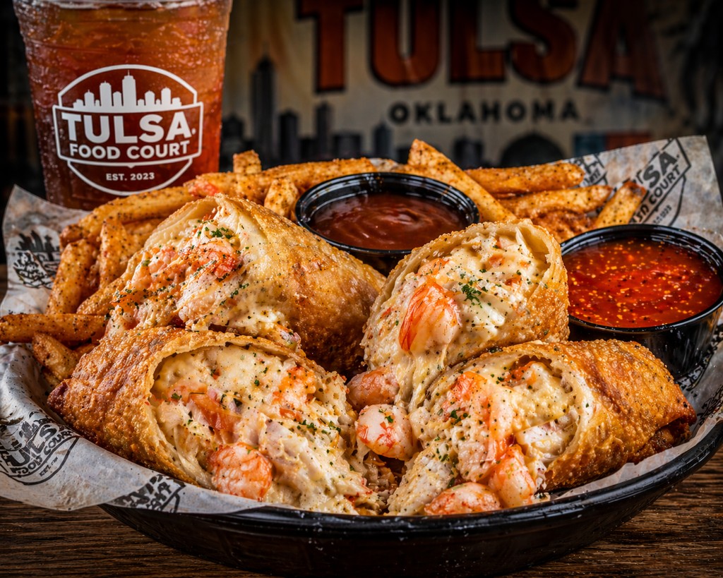 Seafood egg rolls with shrimp and crab, melted cheese, seasoned fries, and dipping sauces
